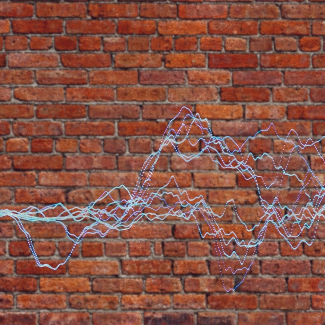 Image shows a brick wall with sound frequency graph overlaid