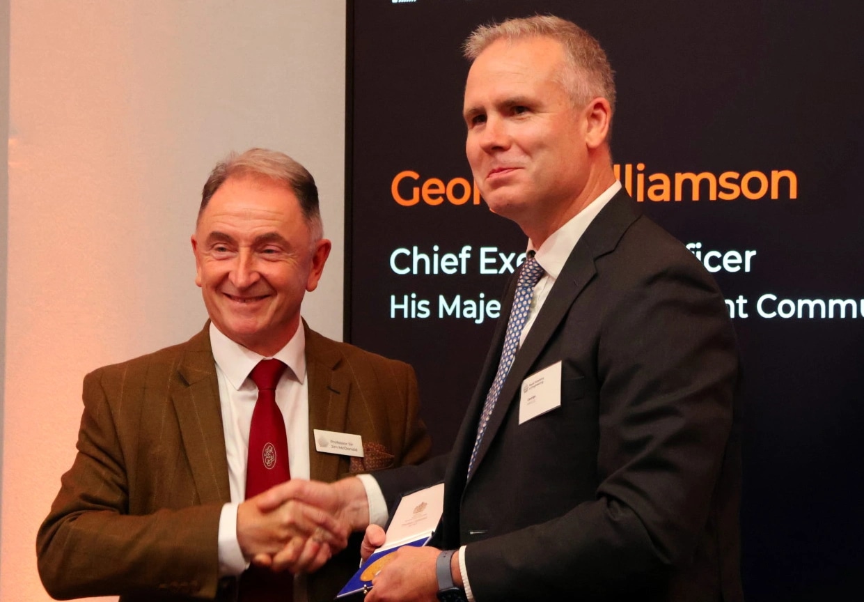 HMGCC CEO George Williams collects an award on behalf of HMGCC from Royal Academy of Engineering President Professor Sir Jim McDonald