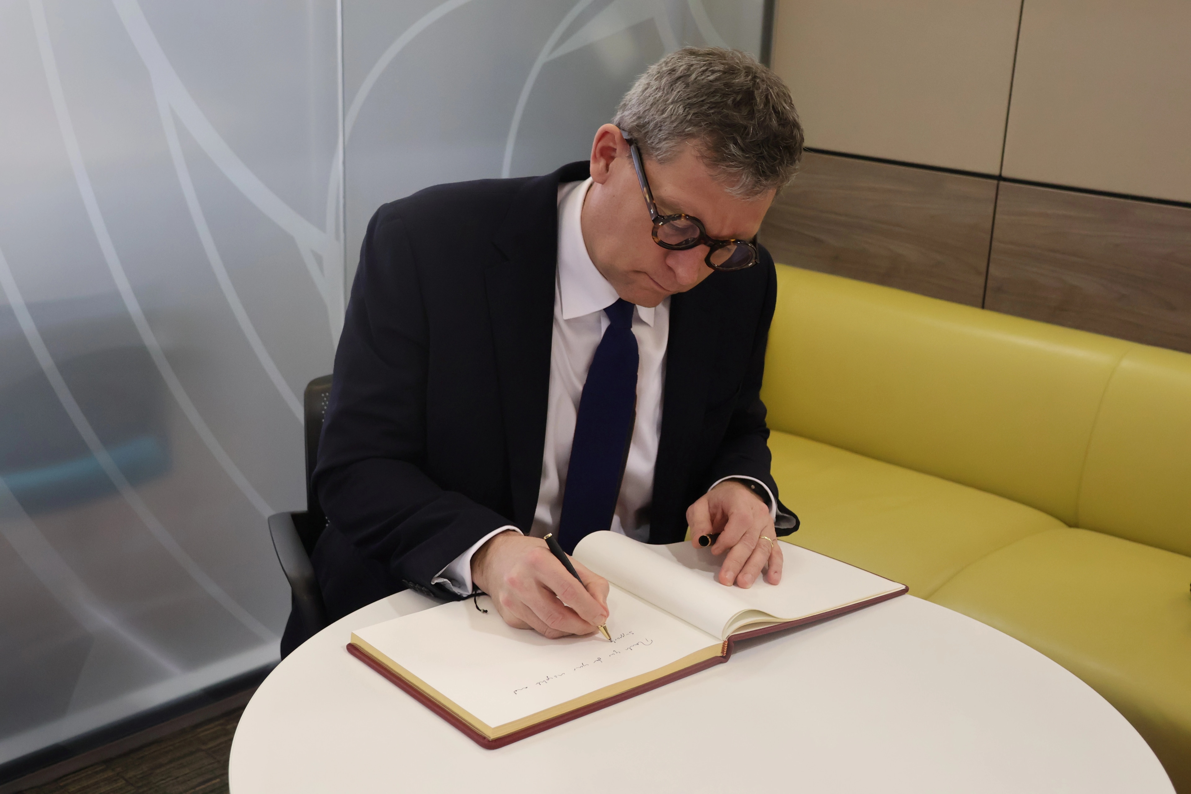 Lord Timpson signing HMGCC visitor book