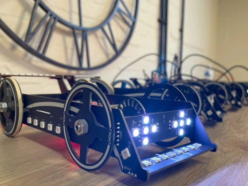 Remote control cars sit on a desk