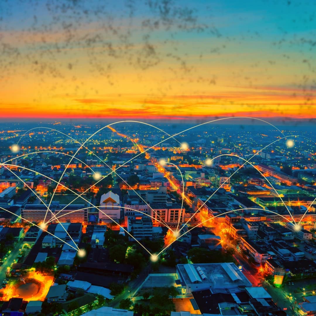 Image shows a cityscape, with points of light throughout, and fine lines connecting them