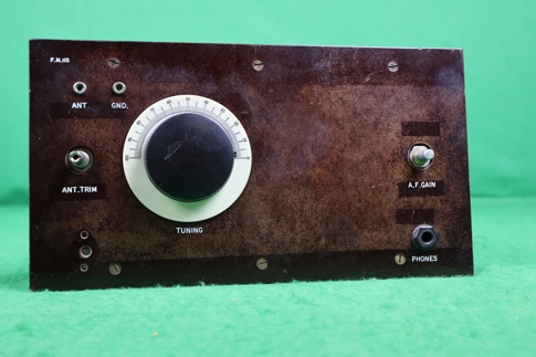 Image shows radio transmitter featuring tuning dial and a range of ports and switches