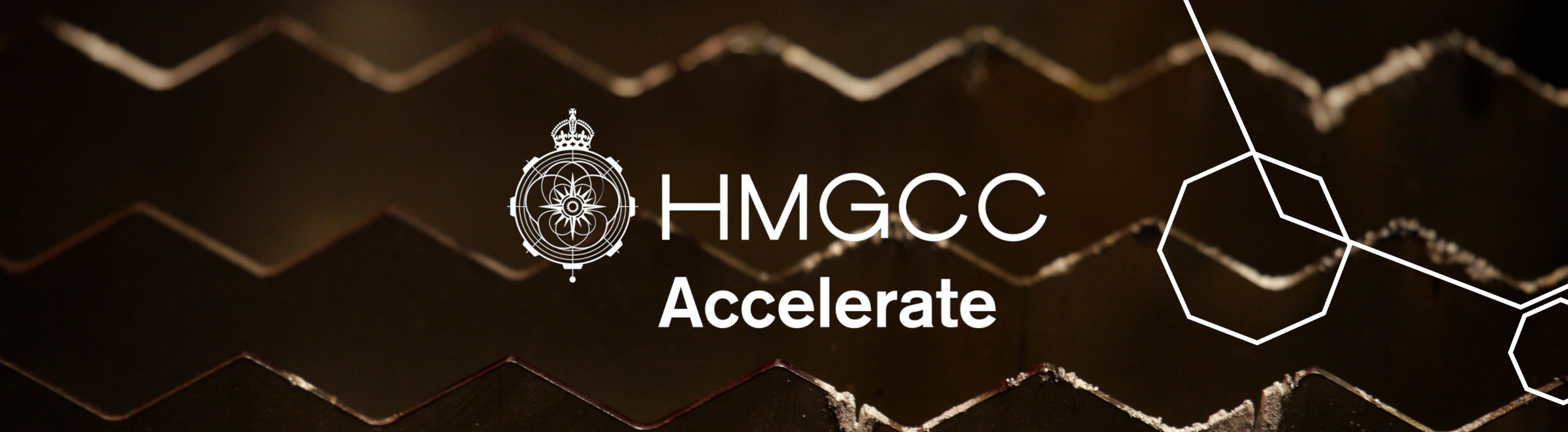HMGCC Accelerate Logo with HMGCC Crown emblem and Octagon design elements 